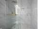 Modern walk-in shower with glass enclosure, rainfall shower head, and marble tile creates a luxurious experience at 12516 Schoolhouse Rd, Fishers, IN 46037