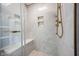 Stylish shower with glass enclosure, built-in shelving, and modern fixtures at 12516 Schoolhouse Rd, Fishers, IN 46037