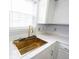 Close up of a stylish kitchen with a gold sink, quartz countertops, and white cabinets at 12516 Schoolhouse Rd, Fishers, IN 46037