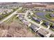 An aerial shot showcases a community with manicured landscaping, a tranquil pond, and well-spaced homes, ideal for relaxed living at 12598 Coastal Pl, Fishers, IN 46037
