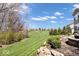 Expansive backyard featuring a lush lawn and scenic landscaping with mature trees at 12598 Coastal Pl, Fishers, IN 46037