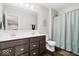 Bathroom with a double sink vanity, large mirror, and shower with a curtain at 12598 Coastal Pl, Fishers, IN 46037
