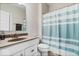 Neat bathroom with clean white vanity and a light blue and white striped shower curtain at 12598 Coastal Pl, Fishers, IN 46037