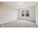 Bedroom with neutral walls and carpet featuring a large window at 12598 Coastal Pl, Fishers, IN 46037