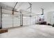 Spacious three car garage featuring white doors, automatic door openers, and a clean concrete floor at 12598 Coastal Pl, Fishers, IN 46037