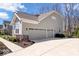 Attached two-car garage showcasing driveway and tasteful landscaping at 12598 Coastal Pl, Fishers, IN 46037