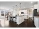 Modern kitchen with a large island, stainless steel appliances, and adjacent dining area at 12598 Coastal Pl, Fishers, IN 46037