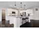 Well-lit kitchen with a granite-topped island, stainless steel appliances, and white cabinets at 12598 Coastal Pl, Fishers, IN 46037