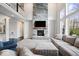 Inviting living room with stone fireplace, soaring ceilings and large windows offering abundant natural light at 12598 Coastal Pl, Fishers, IN 46037