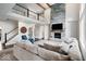 Open-concept living room with fireplace, second-story balcony, and large windows for natural light at 12598 Coastal Pl, Fishers, IN 46037
