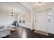 Bright living room featuring hardwood floors, wainscoting, and a chandelier at 12598 Coastal Pl, Fishers, IN 46037