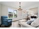 Cozy living room with large windows offering views of the front yard, and comfortable seating at 12598 Coastal Pl, Fishers, IN 46037