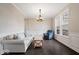 Bright living room with hardwood floors, wainscoting, and a comfortable seating arrangement at 12598 Coastal Pl, Fishers, IN 46037