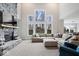 Bright living room with a floor-to-ceiling fireplace, large windows, and an open concept design at 12598 Coastal Pl, Fishers, IN 46037