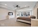 Bright main bedroom featuring a tray ceiling, large windows, and ample space for furniture at 12598 Coastal Pl, Fishers, IN 46037