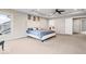 Airy main bedroom with a large bed, carpet, and a view to the backyard at 12598 Coastal Pl, Fishers, IN 46037