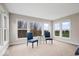 Sitting area features large windows and blue accent chairs at 12598 Coastal Pl, Fishers, IN 46037