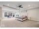 Spacious main bedroom with a ceiling fan, large windows, and neutral decor at 12598 Coastal Pl, Fishers, IN 46037