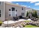 Landscaped patio area with a dining table, outdoor fireplace, and comfortable seating at 12598 Coastal Pl, Fishers, IN 46037