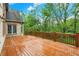 Deck with stained wood railings offers an outdoor space with a view of lush greenery at 13758 Foxdale Lake Dr, Carmel, IN 46032