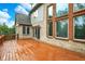 Spacious stained-wood deck offering outdoor living with a brick house exterior and lush greenery views at 13758 Foxdale Lake Dr, Carmel, IN 46032