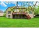 Exterior of a two-story brick home showcasing a spacious backyard, deck, and lush green lawn at 13758 Foxdale Lake Dr, Carmel, IN 46032