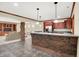 Finished basement boasts a brick bar area, stainless steel refrigerator, and recessed lighting at 13758 Foxdale Lake Dr, Carmel, IN 46032