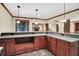 View of basement bar, cabinets, recessed lighting, and distant fireplace at 13758 Foxdale Lake Dr, Carmel, IN 46032
