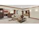Basement living area with brick columns leading to bar, kitchen and second living area at 13758 Foxdale Lake Dr, Carmel, IN 46032