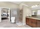Beautiful primary bathroom featuring a glass block shower and double vanity at 13758 Foxdale Lake Dr, Carmel, IN 46032