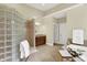 Bright bathroom features a glass block shower, soaking tub, vanity and neutral tile flooring at 13758 Foxdale Lake Dr, Carmel, IN 46032