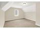 Empty bedroom showcasing neutral carpet and paint, an overhead light, and a window with blinds at 13758 Foxdale Lake Dr, Carmel, IN 46032