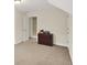A room with neutral paint, a dark wood dresser, and view to white door at 13758 Foxdale Lake Dr, Carmel, IN 46032