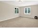 Spacious bedroom with neutral paint, carpeted floors, and bright, natural light from the double windows at 13758 Foxdale Lake Dr, Carmel, IN 46032