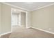 A simple bedroom with beige walls and carpet and white trim at 13758 Foxdale Lake Dr, Carmel, IN 46032