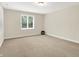 A simple bedroom with a single window and beige walls and carpet at 13758 Foxdale Lake Dr, Carmel, IN 46032