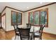 Bright dining room with large windows and decorative chairs around a glass table at 13758 Foxdale Lake Dr, Carmel, IN 46032