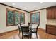 Elegant dining area with hardwood floors and many windows for natural light at 13758 Foxdale Lake Dr, Carmel, IN 46032