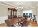 Formal dining room featuring a large table, elegant chandelier, and classic decor at 13758 Foxdale Lake Dr, Carmel, IN 46032