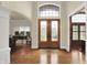 Grand foyer with hardwood floors, decorative front door, and arched doorway at 13758 Foxdale Lake Dr, Carmel, IN 46032