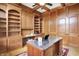 Well-appointed home office with custom built-ins, a ceiling fan, and a work desk at 13758 Foxdale Lake Dr, Carmel, IN 46032