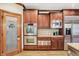 Well-equipped kitchen with stainless steel appliances, double oven, and access to a walk-in pantry at 13758 Foxdale Lake Dr, Carmel, IN 46032