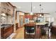 Modern kitchen with brick oven hood, stainless steel appliances and hardwood floors at 13758 Foxdale Lake Dr, Carmel, IN 46032