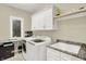 Bright laundry room features modern washer/dryer and custom storage at 13758 Foxdale Lake Dr, Carmel, IN 46032
