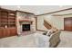 Inviting living room with a stone fireplace, built-in shelving, and comfortable seating at 13758 Foxdale Lake Dr, Carmel, IN 46032