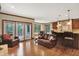 Open-concept living room with hardwood floors, and access to the kitchen and patio at 13758 Foxdale Lake Dr, Carmel, IN 46032