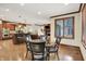Open-concept living space featuring hardwood floors, dining area, kitchen, and fireplace at 13758 Foxdale Lake Dr, Carmel, IN 46032