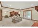 Basement living room with comfortable sofa, adjacent to kitchen with bar and french doors at 13758 Foxdale Lake Dr, Carmel, IN 46032