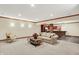 Basement living area with furniture, leads to open kitchen and bar area separated by brick column at 13758 Foxdale Lake Dr, Carmel, IN 46032