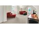 Comfortable seating area with plush red couches, soft carpet, and natural light at 13758 Foxdale Lake Dr, Carmel, IN 46032